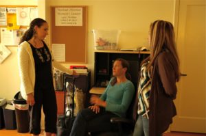 Kristie Clemens (center) and administrative staff of the Walnut Avenue Women’s Center are responsible for making sure the money that has been restored goes to those who need it. Photo by Kathryn Power.
