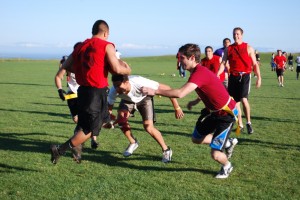 The ’69ers flag football team practices on the East Field. Photo by Rosario Serna.