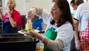 A Project Homeless Connect (PHC) volunteer prepares a plate of spaghetti during the PHC event on April 9. Photo by Daniel Green.