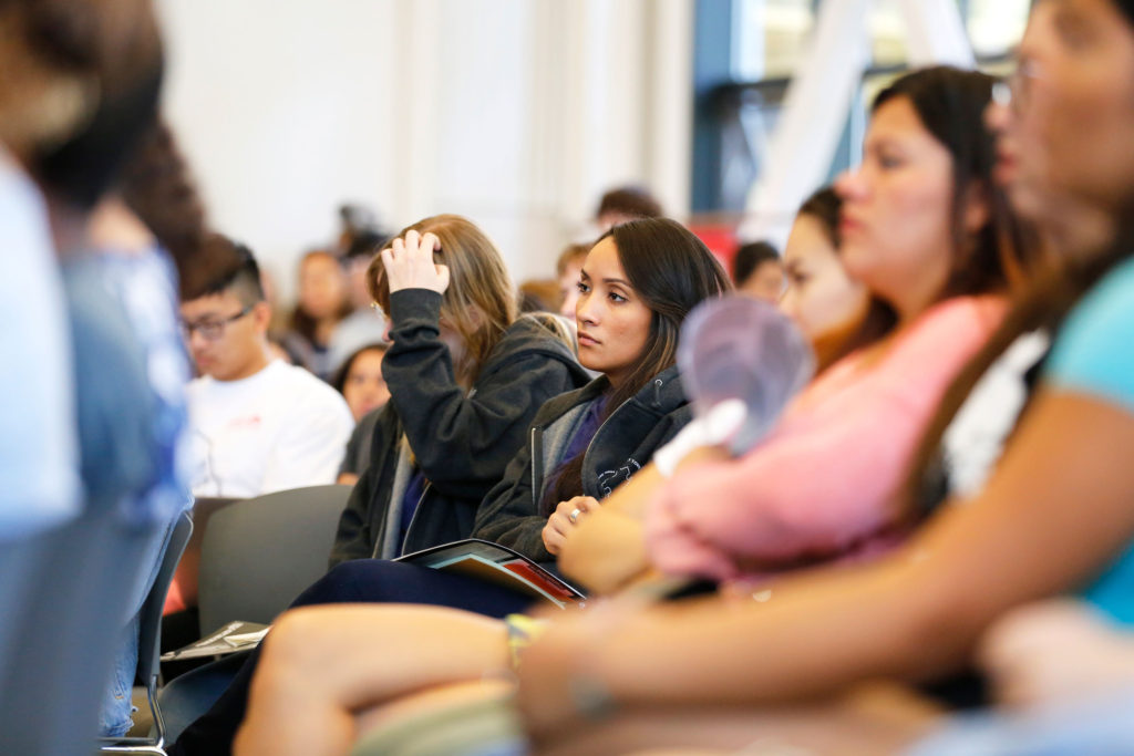 A UCSC student listens during one of the speeches. Numerous workshops led by students discussed issues like environmental justice, Islamophobia and mental health. Photo by Stephen de Ropp